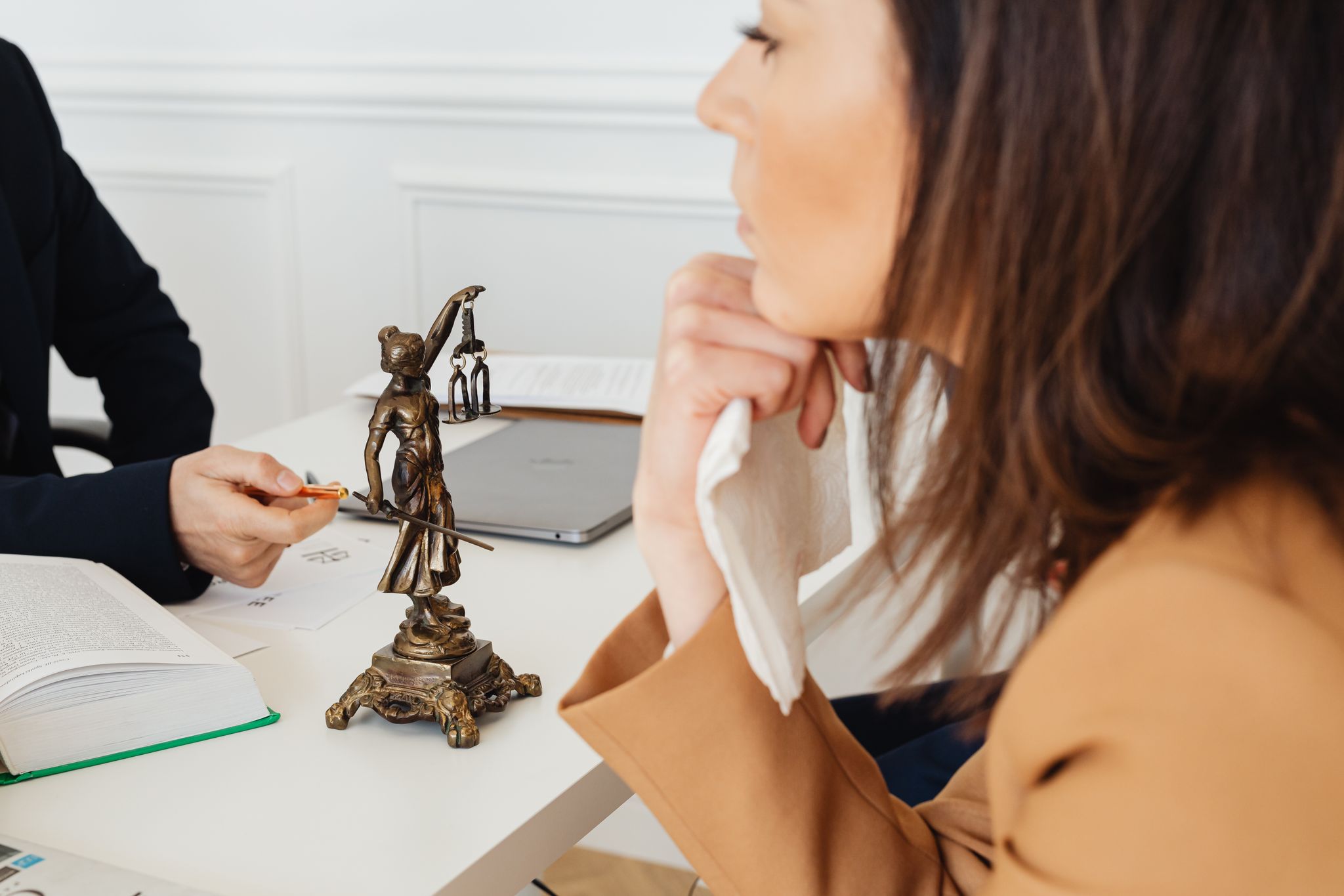 A probate law setting with a Lady Justice statue, two individuals discussing legal matters.